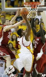 Southern California's Davon Jefferson (5) drives to the basket between Oklahoma's Blake Griffin (23) and Longar Longar (30) during the first half. (AP Photo/Gus Ruelas)