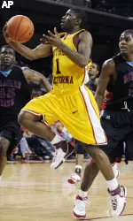 Angelo Johnson, center, drives past Delaware State's Roy Bright, left, and Frisco Sandidge during the second half. (AP Photo/Chris Pizzello)