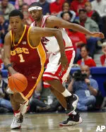 Nick Young races past Arizona's Mustafa Shakur in the Trojans' 80-75 win. (AP Photo/Wily Low)