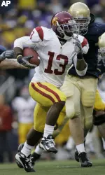 USC tailback Stafon Johnson carries the ball as Washington defensive tackle Jordan Reffett pursues during the first quarter. (AP Photo/Ted S. Warren)