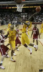 USC's O.J. Mayo, right, goes up to the basket with the ball against Washington State's Daven Hermeling, left, Robbie Cowgill (34) and Kyle Weaver (25), during the first half. (AP Photo/Francis Specker)
