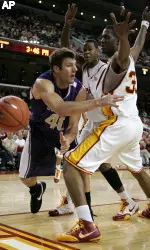 Washington's Jon Brockman, left, loses the ball while being defended by USC's Davon Jefferson, center, and Rousean Cromwell during the first half. (AP Photo/Jeff Lewis)