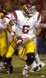 Quarterback Mark Sanchez prepares to hand the ball off in the backfield.