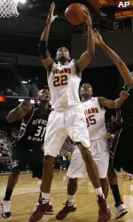 Southern California's Taj Gibson pulls down a rebound over New Mexico State's Wendell McKines, left, and Troy Gillenwater, right, as Southern Cal's Donte Smith looks on during the second half. (AP Photo/Danny Moloshok)