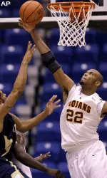 Taj Gibson blocks a shot of Chattanooga's Dante Harvey. Gibson had five blocks in the game.