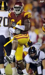 USC defensive end Kyle Moore, left, celebrates after sacking California quarterback Kevin Riley, lower right, during the second half. (AP Photo/Mark J. Terrill)