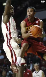 Southern California guard Dwight Lewis, right, goes up for a shot in front of Oklahoma forward Ryan Wright, left, in the first half. (AP Photo/Sue Ogrocki)