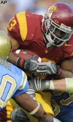 Southern California running back Stafon Johnson scores between UCLA safety Glenn Love, left, and cornerback Lowell Rose during the first half. (AP Photo/Chris Carlson)