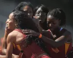 Senior Carol Rodriguez gets congratulations after her brilliant third leg led USC to the win in the 4x400m relay.