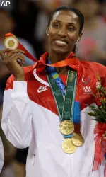 USC's Lisa Leslie displays her historic four Olympic gold medals.