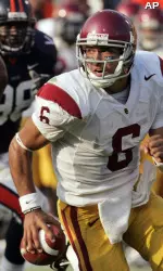 Mark Sanchez looks for daylight against Virginia. He threw for three touchdown passes in a 52-7 win. (AP Photo/Steve Helber)