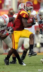 USC running back Joe McKnight (4) tries to break the tackle of Ohio State defensive back Donald Washington, left, and linebacker James Laurinaitis during the first half. (AP Photo/Mark J. Terrill)