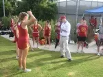Coach Tom Walsh talks to the team before the UC Irvine Invitational while former runner Christina Eads (right) looks on.