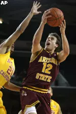 Arizona State's Derek Glasser lays the ball up while being guarded by Southern California's Dwight Lewis during the first half.
