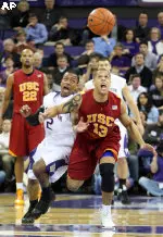 Washington's Isaiah Thomas and Daniel Hackett reach for the ball in the first half.