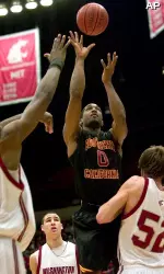 Southern California forward Marcus Johnson (0) shoots over Washington State forwards Caleb Forrest (52) and DeAngelo Casto, left, during the first half. (AP Photo/Dean Hare)
