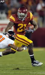 Allen Bradford, right, fends off Oregon State cornerback Tim Clark (21) as defensive end Gabe Miller (99) and linebacker Keith Pankey (35) give chase during the first half.