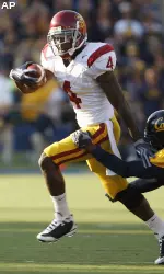 Joe McKnight breaks the tackle of California's Syd'Quan Thompson on a touchdown run during the first quarter.