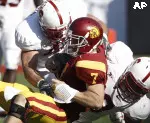 Matt Barkley, center, is sacked by Stanford's Matt Masifilo, right, and Will Powers during the first half.