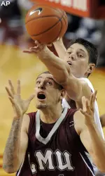 Nikola Vucevic reaches over Loyola Maymount's Edgar Garibay for a rebound.