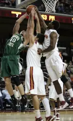 Sacramento State center Justin Eller (40) tries to shoot by Southern California forward Nikola Vucevic, center, and Southern California forward Alex Stepheson, right, in the first half. (AP Photo/Jason Redmond)