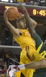 USC's Dwight Lewis (21) drives to the basket as Oregon's Josh Crittle (42) defends during the second half. (AP Photo/Hector Mata)