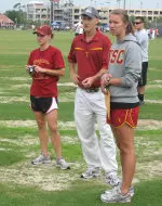 Coach Walsh looks on flanked by Zsofia Erdelyi on the left and Jennifer Wells on the right.