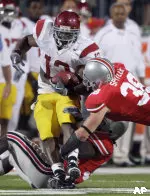 Stafon Johnson is tackled by Ohio State linebacker Brian Rolle, bottom, and linebacker Austin Spitler (38) on Saturday.