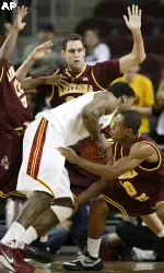 Southern California forward Alex Stepheson, center, fights for possession with three Arizona State defenders in the first half of their NCAA college basketball game in Los Angeles on Saturday, Jan. 2, 2010. (AP Photo/Jason Redmond)
