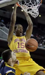 Southern California's Bryce Jones, top, dunks over UC Irvine's Pavol Losonsky during the first half.