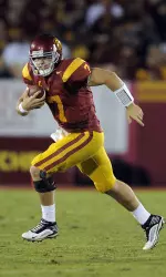 Southern California quarterback Matt Barkley, left, runs as Arizona State defensive end James Brooks gives chase during the first half.