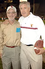 Longtime USC football statistician Ned Miller, pictured with former USC head coach Pete Carroll, worked USC games since 1956.