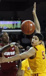 Jeremy Green, left, passes the ball as Southern California's Nikola Vucevic (5) defends in the first half.