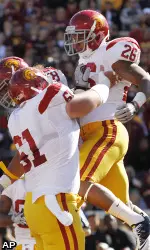 Southern California running back Marc Tyler celebrates his first quarter touchdown with teammate Kristofer O'Dowd.