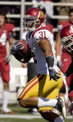 Stanley Havili (31) outruns Washington State safety Tyree Toomer, center, as he scores a touchdown on USC's first play from scrimmage.