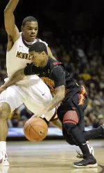 Southern California guard Maurice Jones, right, drives against Minnesota guard Andre Hollins during the first half.