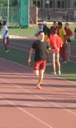 Tony Martinez eases up before the finish line for the winning Black team at the 2011 USC Challenge Relays.