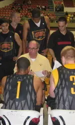 Head coach Kevin O'Neill addresses the team before the game starts.