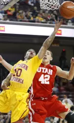 USC's Maurice Jones makes a basket over Utah's  Jason Washburn.