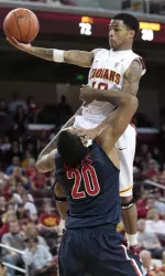 Southern California guard Maurice Jones, top, goes for a layup over Arizona guard Jordin Mayes in the second half.