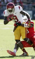 Marqise Lee is dragged down near the sidelines.