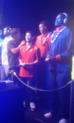 Tyler Sugiyama, with help from Renaldo Woolridge, competed in the video game challenge at the Players Dinner on Saturday.