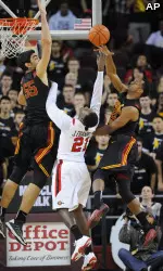 USC center Omar Oraby (55) and guard Byron Wesley, right, fight for a rebound. (AP Photo/Gus Ruelas)