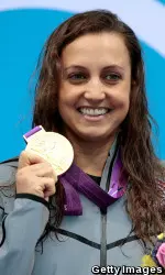 Rebecca Soni holds up her gold medal after winning the 200m breaststroke at the 2012 London Olympics, repeating her title from 2008.