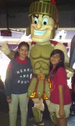 Tommy Trojan poses with local kids.