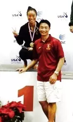 Former USC NCAA champion Victoria Ishimatsu on the podium with USC Coach Hongping Li after winning a U.S. title on 1-meter Tuesday.