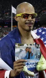 Felix Sanchez shown here after winning the 400m IH Olympic Gold at the 2012 London Games. He is holding a photo of his grandmother Lilian Pena.