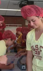 Junior Brianna Weinstein packs a meal with her teammates.