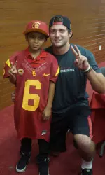 Quarterback Cody Kessler poses with young Trojan Joey Rodriguez.