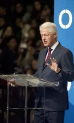 Former President Clinton addresses a crowd of 8,000 during a financial literacy education event on Sunday at Galen Center.